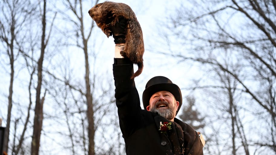 A man holds up Punxsutawney Phil for the 2023 Groundhog Day celebration.