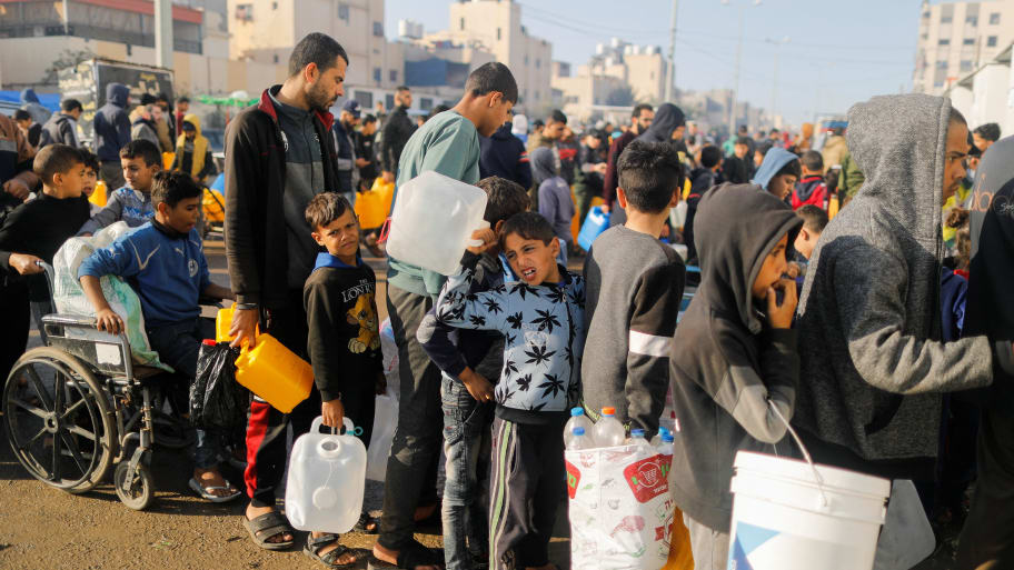 Palestinians queue as they wait to collect drinking water, amid shortages of drinking water, as the conflict between Israel and Hamas continues, in Rafah, in the southern Gaza Strip January 4, 2024.