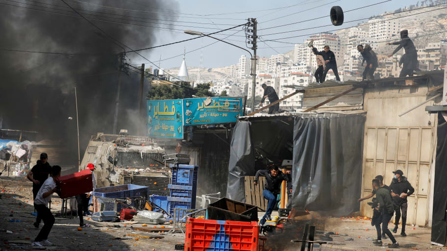 Palestinians clash with Israeli forces during a raid in Nablus in the Israeli-occupied West bank, February 22, 2023.