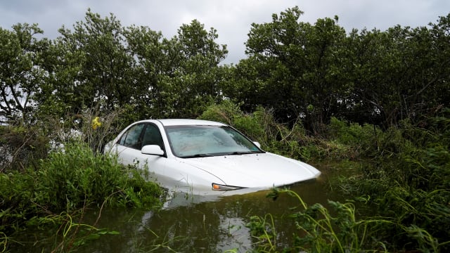 A vehicle is partially submerged after the arrival of Hurricane Idalia, in Cedar Key, Florida
