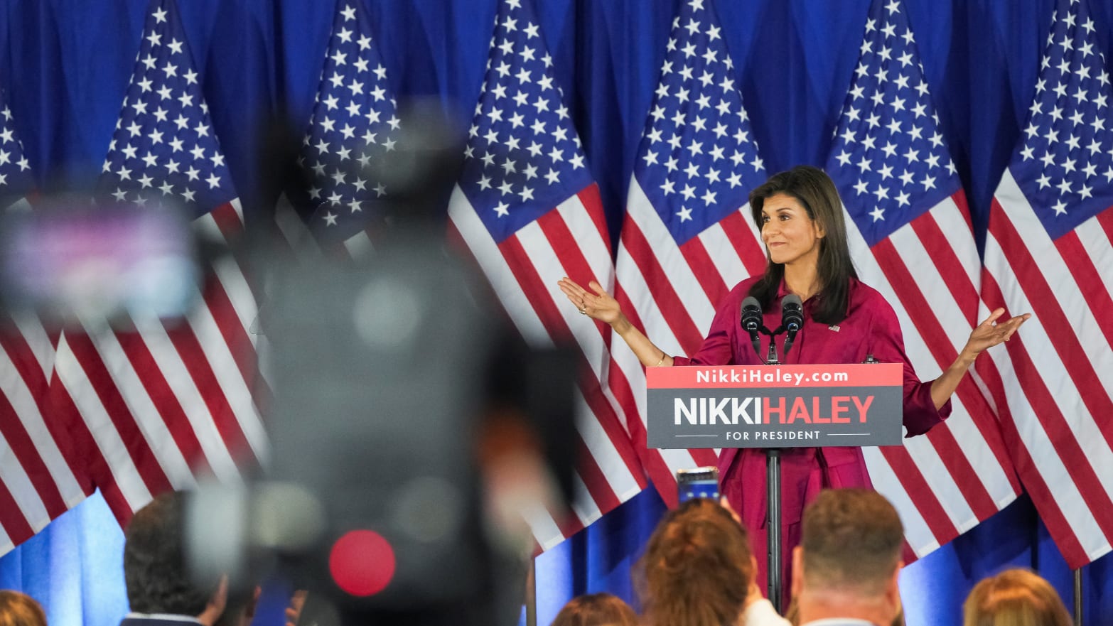 Republican presidential candidate and former U.S. Ambassador to the United Nations Nikki Haley gestures as she speaks to the crowd at a caucus night party in Iowa. 