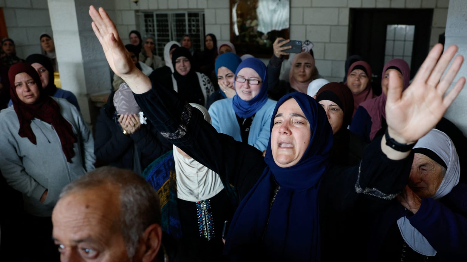 Mourners react during the funeral of American-Palestinian Tawfiq Ajaq, 17, who Palestinian officials say was killed by the Israeli security forces in the West Bank.