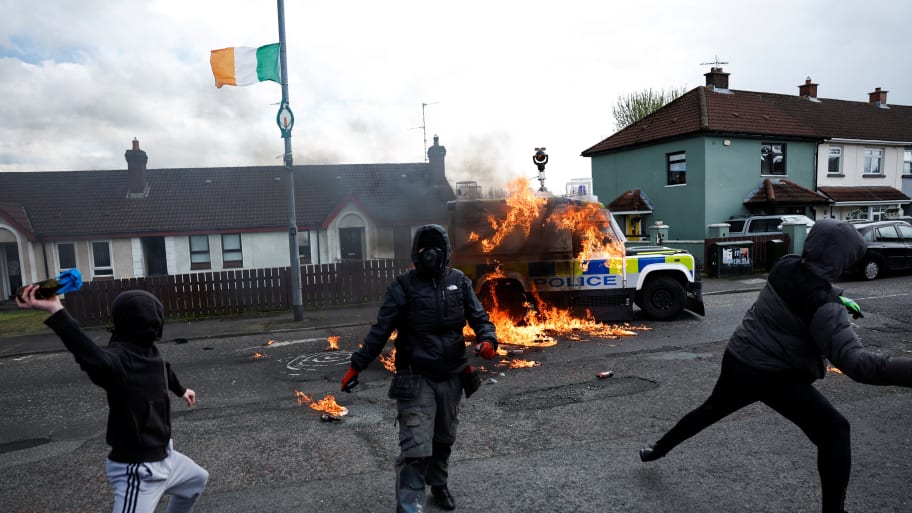 Members of nationalist group 'Dissident Republicans' throw petrol bombs at a police car as nationalists hold an anti-agreement rally on the 25th anniversary of the peace deal, in Londonderry, Northern Ireland.