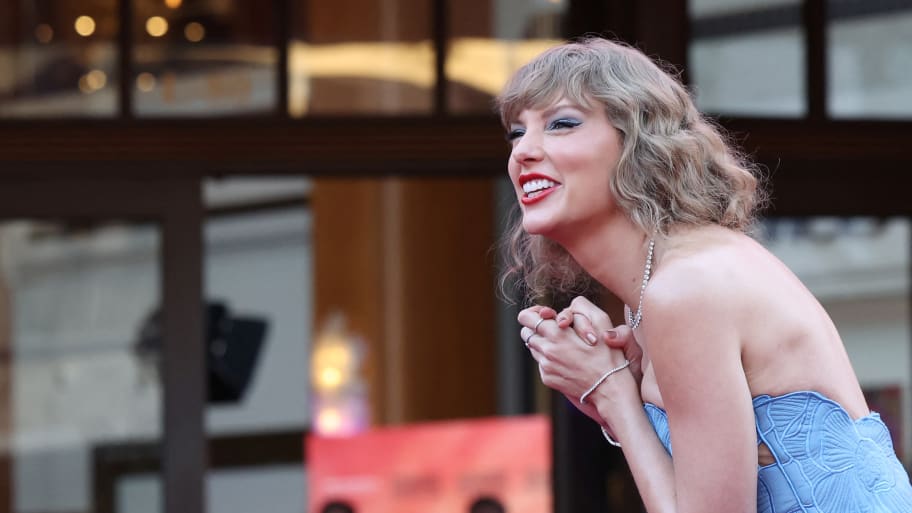 Taylor Swift smiles at the premiere of her concert film in October 2023.