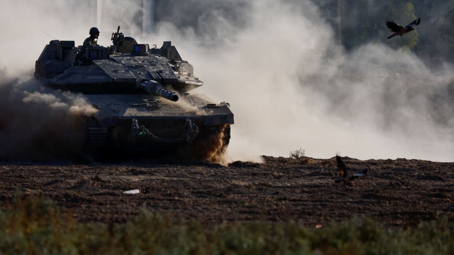 An Israeli tank maneuvers near the Israel-Gaza border, amid the ongoing conflict between Israel and Hamas.