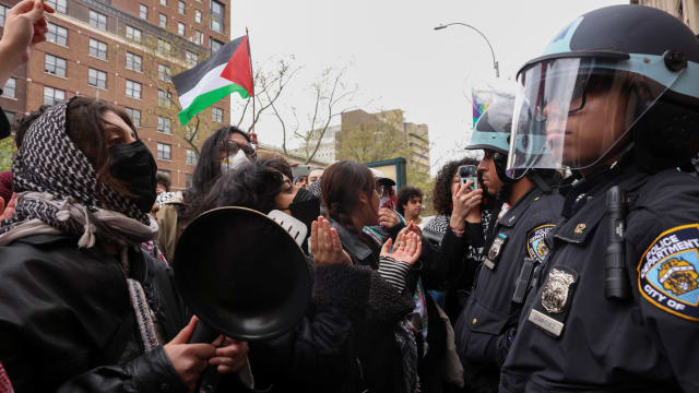 Police officers stand guard as demonstrators protest in solidarity with Pro-Palestinian organizers on the Columbia University campus, amid the ongoing conflict between Israel and the Palestinian Islamist group Hamas, in New York City