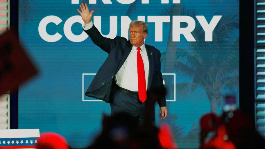 Donald Trump waves to his supporters after giving a campaign speech during the Florida Freedom Summit 