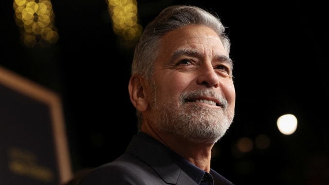 George Clooney smiles at a movie premiere in 2023.