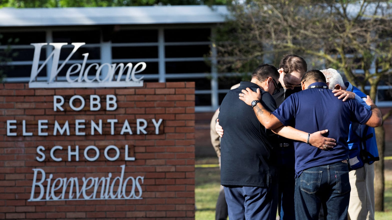 People gather at Robb Elementary School, the scene of a mass shooting.