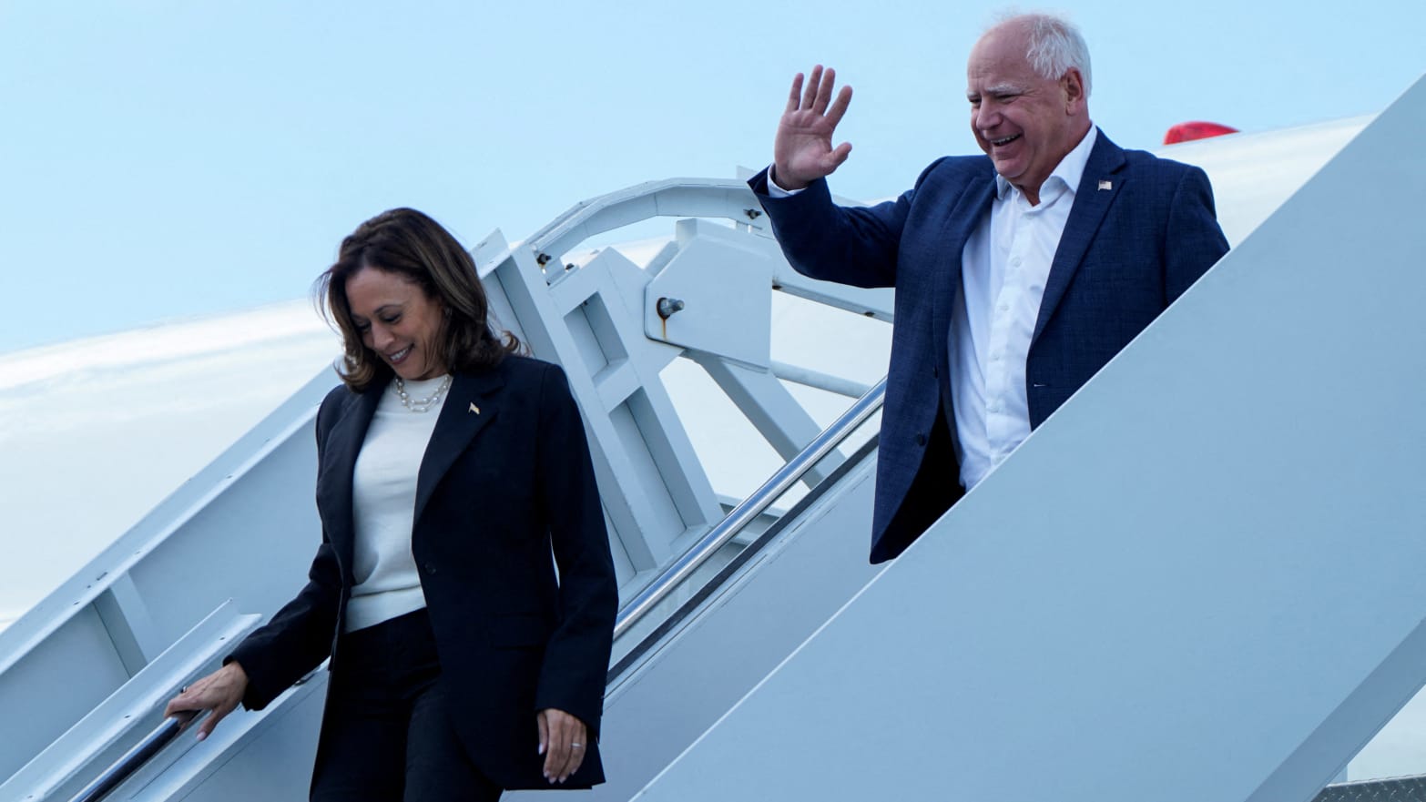 Vice President Kamala Harris and Minnesota Gov. Tim Walz walk down the steps from Air Force Two at Hilton Head International Airport in Savannah, Georgia.