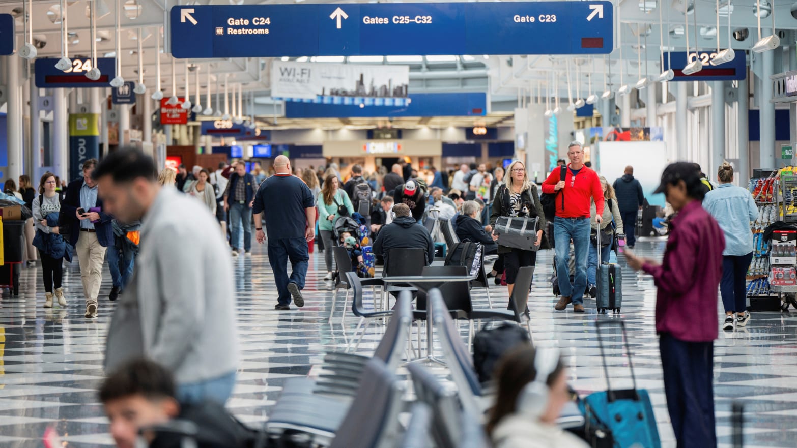 People walk inside a terminal in Chicago O’Hare International Airport.