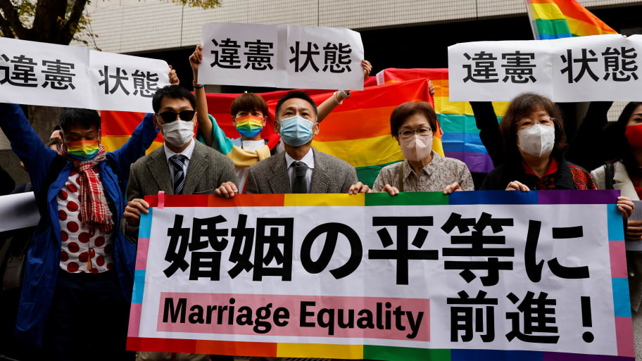 Plaintiffs hold placards outside the court after hearing the ruling on same-sex marriage, in Tokyo, Japan, November 30, 2022. Placards read, “A step towards Marriage Equality.”