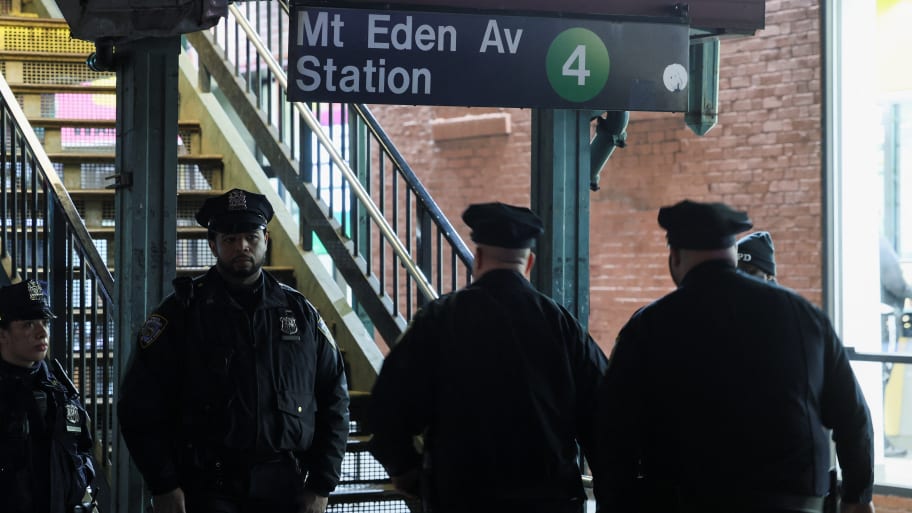 Cops stand in front of the Mount Eden Avenue subway station in the Bronx.