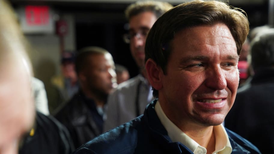 Ron DeSantis gives a half smile while campaigning in New Hampshire.
