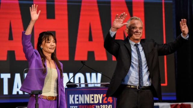 Robert F. Kennedy, Jr. and Nicole Shanahan wave to the audience at the ceremony announcing her selection as his running mate.