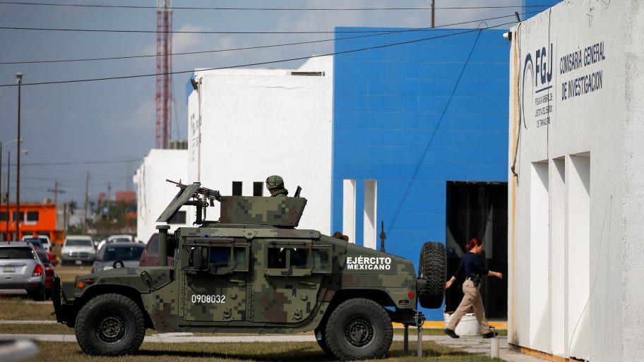 Soldiers stand outside a forensic medical service morgue building in Mexico.