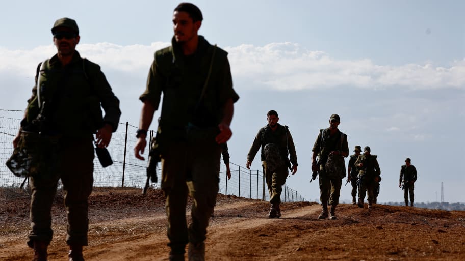 Israeli soldiers patrol an area on the Israeli side of the Israel-Gaza border amid the ongoing conflict between Israel and the Palestinian group Hamas, November 15, 2023.