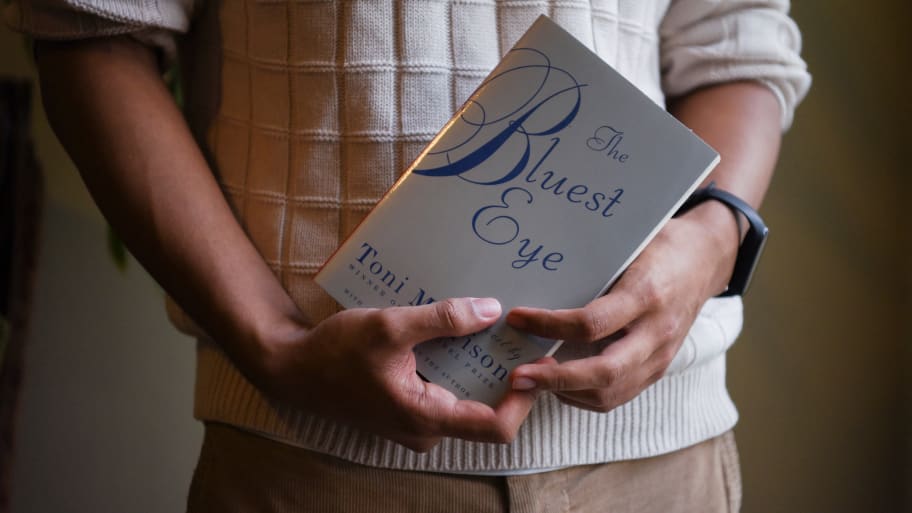 Student holding “The Bluest Eye” by Toni Morrison