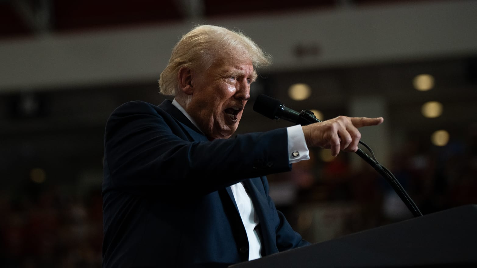 Donald Trump points toward a crowd.