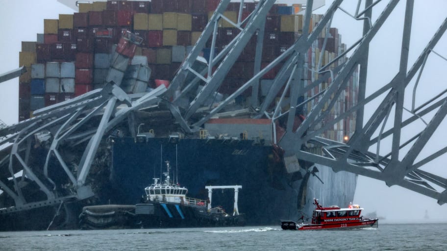 The vessel Dali sits in the Port of Baltimore, with a portion of a collapsed bridge still on top of it.