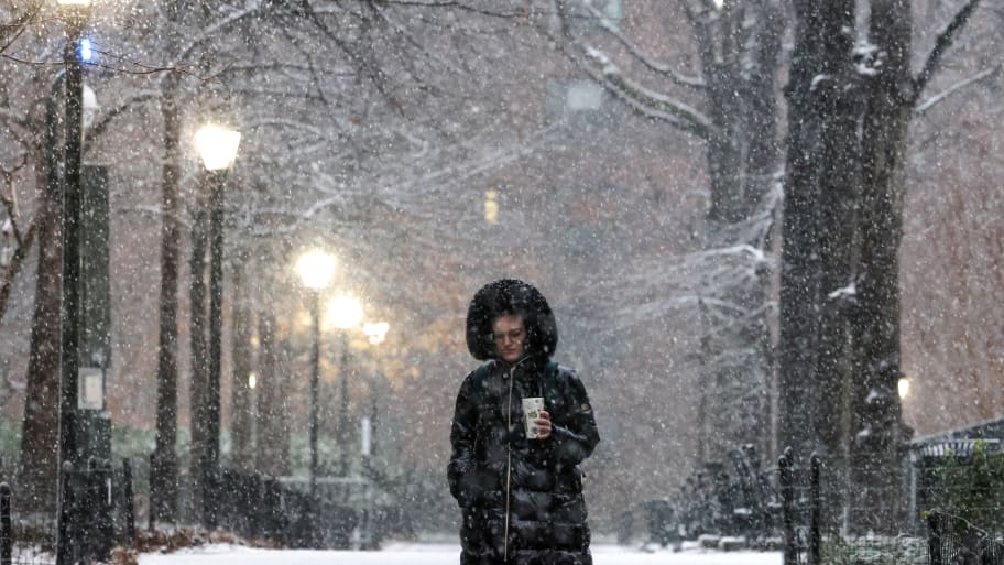A pedestrian stands as the snow falls during a Nor'easter winter storm in New York City, U.S., February 13, 2024. 