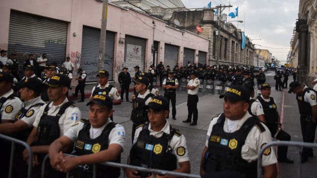 Police officers stand guard on the street of the Congress of Guatemala in Guatemala City, Guatemala, January 14, 2024.