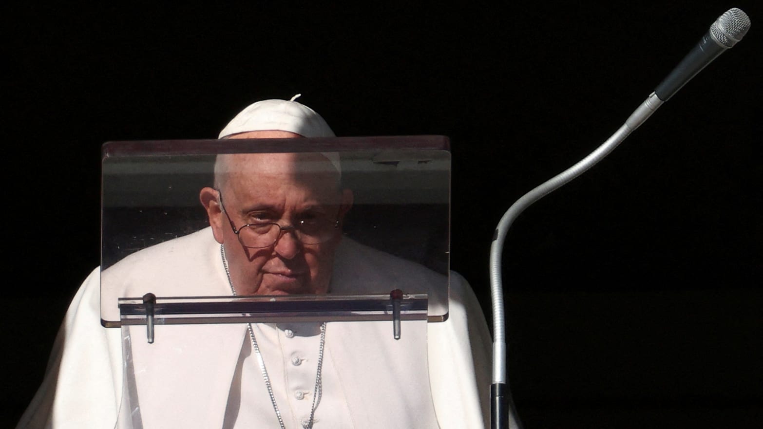 Pope Francis looks on to lead the Angelus prayer from his window