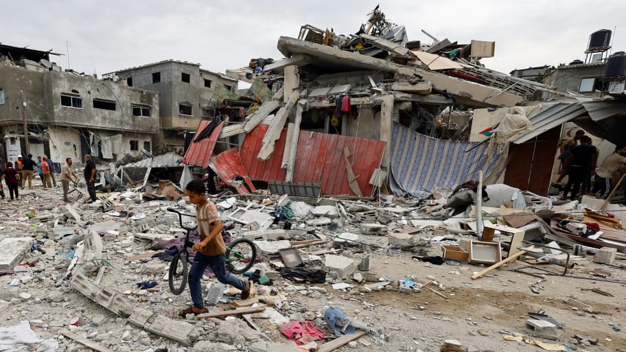 A child walks at the site of an Israeli air strike on a house in Gaza.