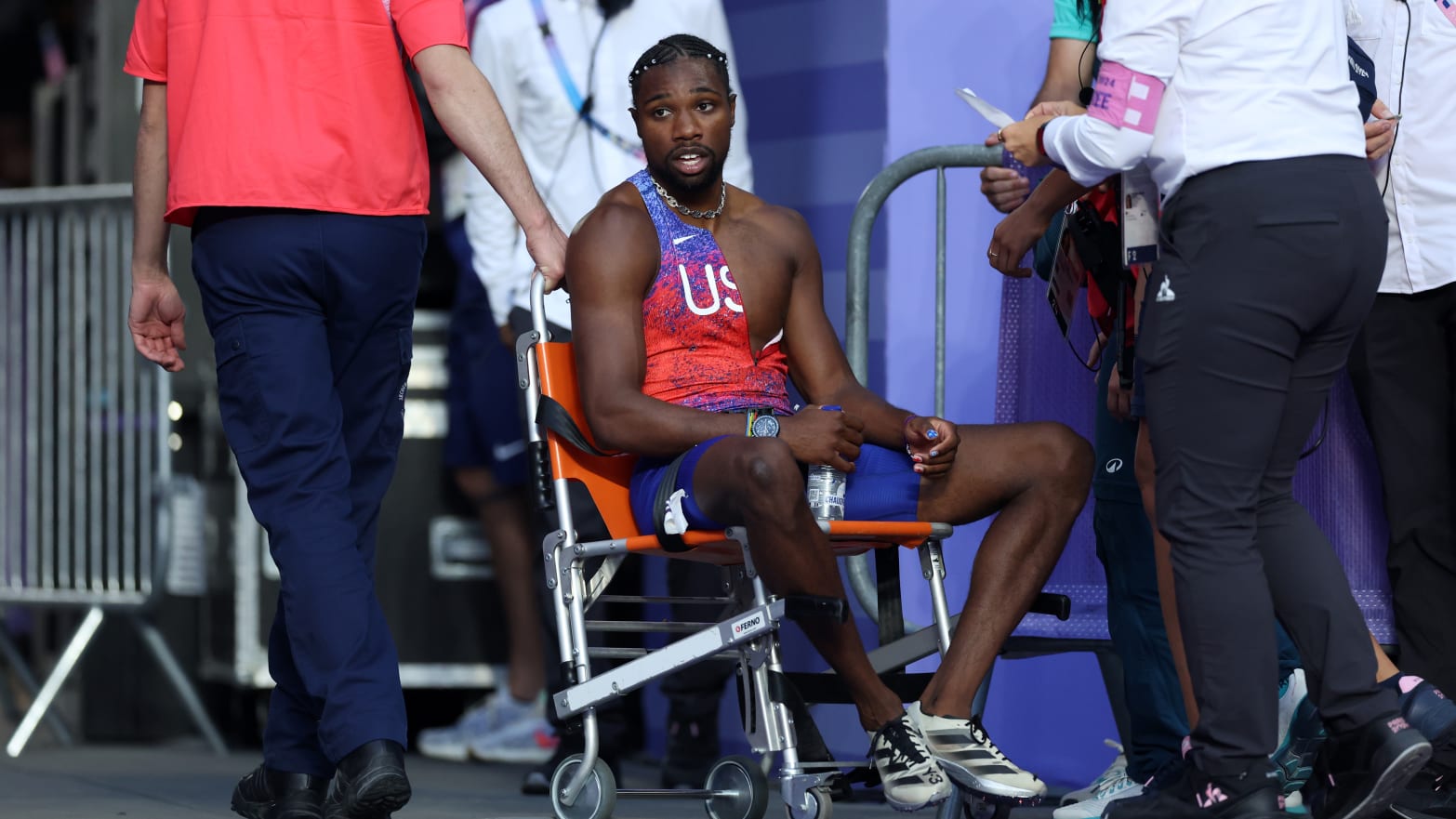 Bronze medalist Noah Lyles of Team United States is taken off from the track with a wheelchair