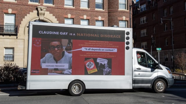 A truck calling the president of Harvard a disgrace drives around Harvard University in Cambridge, Massachusetts.