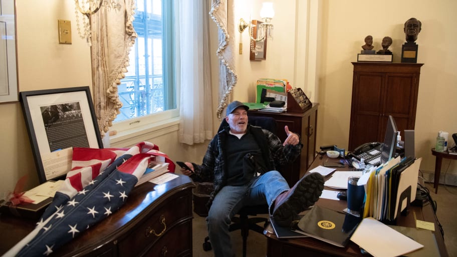 Richard Barnett sitting at Nancy Pelosi's desk