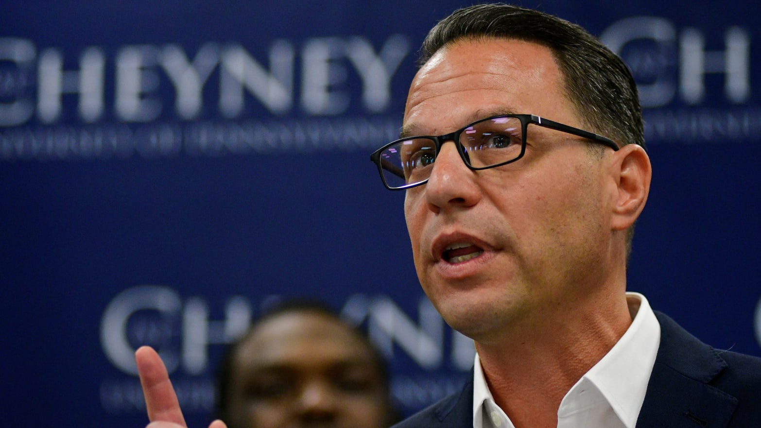 Josh Shapiro raises his index finger while speaking at an event.