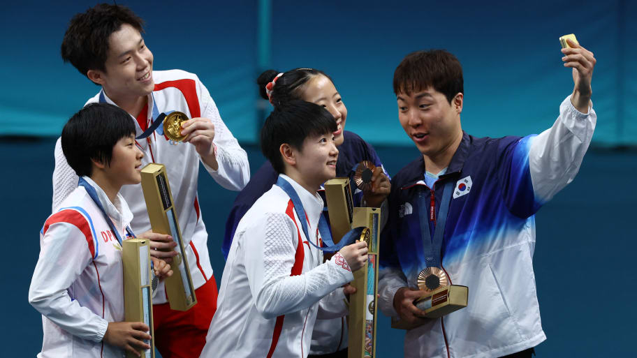 Table tennis medalists from South and North Korea join together for a selfie in Paris