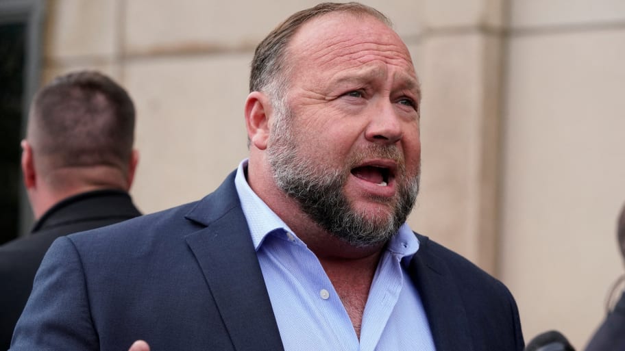 Alex Jones stands outside a courthouse with his mouth open