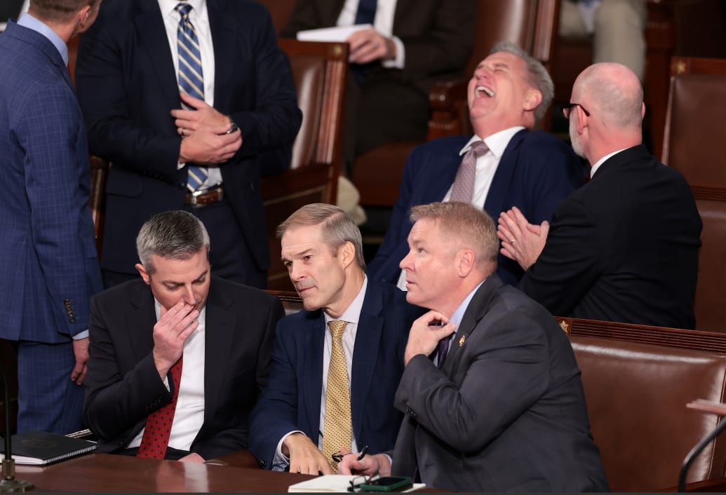 Rep. Jim Jordan (R-OH) talks to a staff member and Rep. Warren Davidson (R-OH) while former Speaker of the House Kevin McCarthy (R-CA) laughs