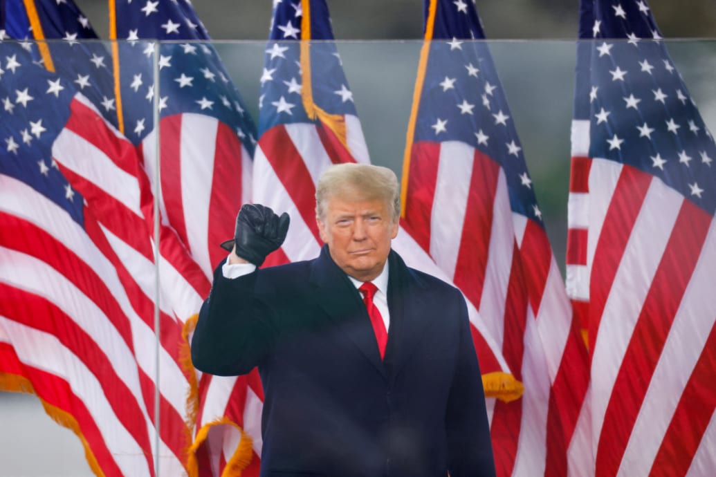 President Donald Trump makes a fist during a rally to contest the certification of the 2020 U.S. presidential election.