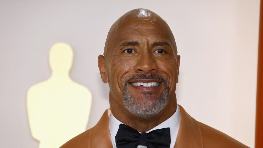 Dwayne Johnson poses on the champagne-colored red carpet during the Oscars arrivals at the 95th Academy Awards in Hollywood, Los Angeles.