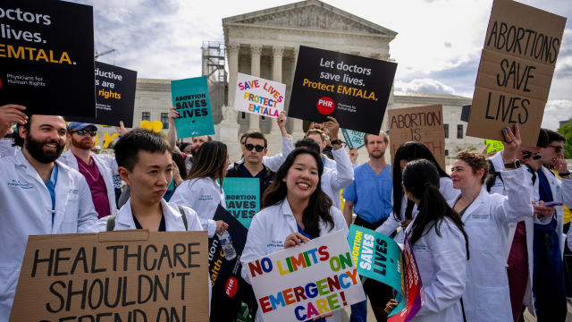 A group of doctors join abortion rights supporters at a rally outside the Supreme Court in April in Washington, D.C. 