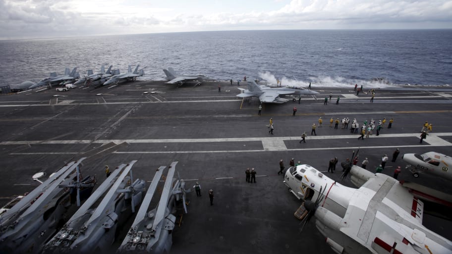 A picture of U.S. Navy F/A-18 Super Hornet fighters are seen on the deck of the USS Ronald Reagan, a super carrier. Two U.S. Navy sailors have been arrested on charges related to national security and tied to China, AP News reported.