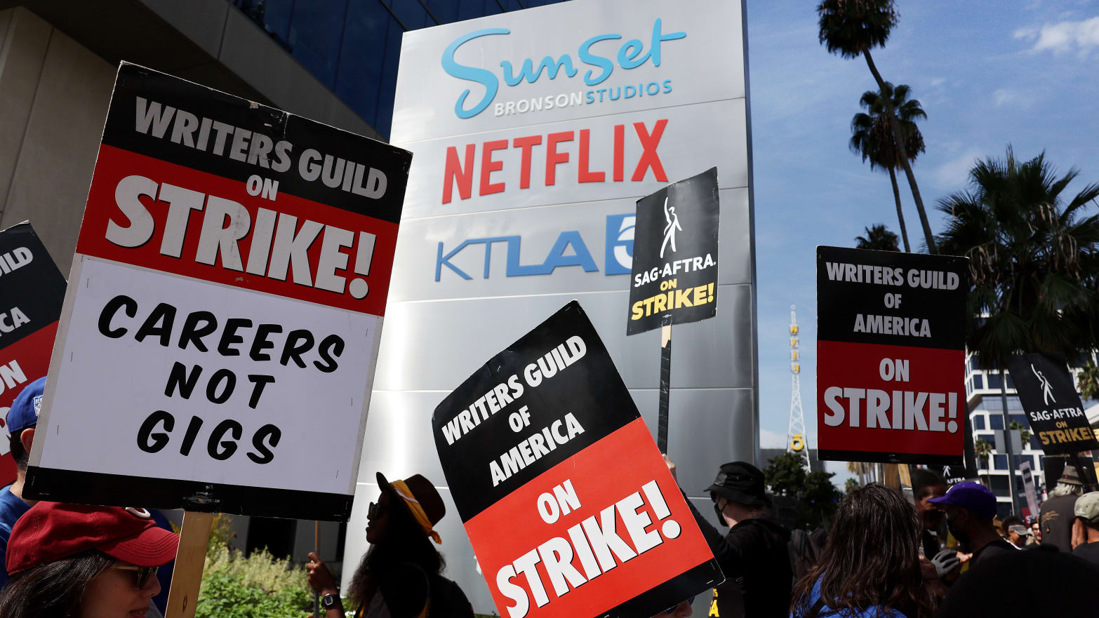 Striking WGA (Writers Guild of America) members picket with striking SAG-AFTRA members outside Netflix studios