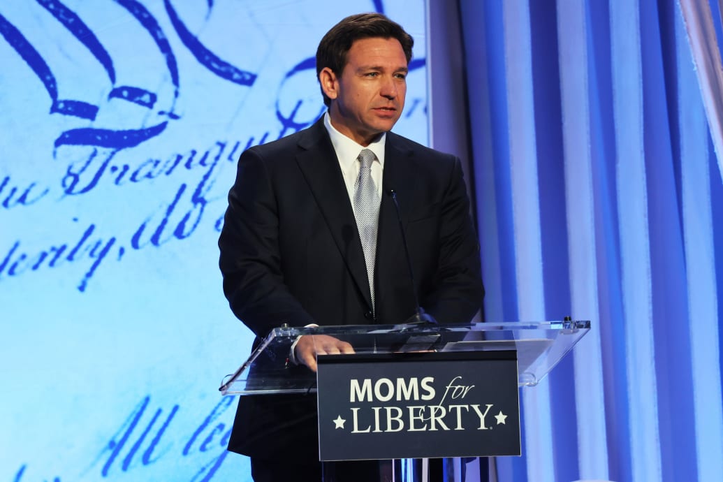 A photograph of Florida Gov. Ron DeSantis speaking at a conference.