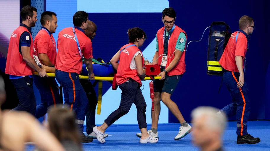 Tamara Potocka is stretchered away from the Paris Olympic pool