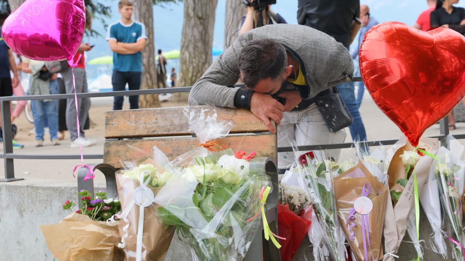 Salih Ismajl cries in front of messages and floral tributes at the children’s playground the day after several children and adults were injured in a knife attack at Le Paquier park near the lake in Annecy, in the French Alps, France, June 9, 2023. 
