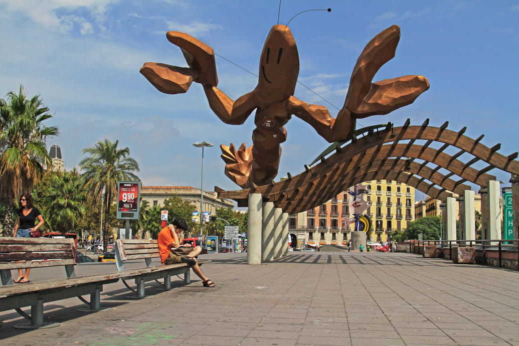 A photograph of Gambrinus, a sculpture by Javier Mariscal, on the waterfront in the old Port of Barcelona.