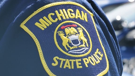 A picture of the Michigan State Police uniform. A 2-year-old girl who went missing alongside her two family dogs in the Michigan woods was found asleep while using one of the family dogs “as a pillow,” local police said Thursday.
