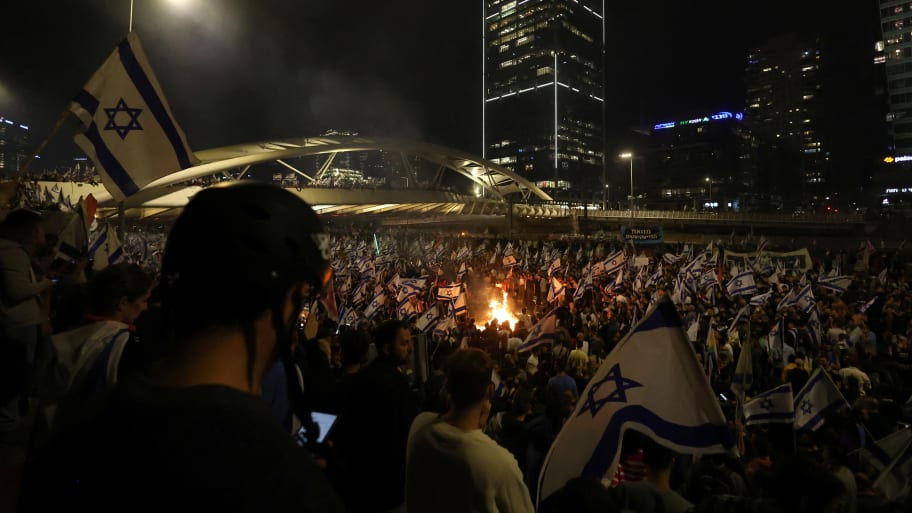 People attend a demonstration after Israeli Prime Minister Benjamin Netanyahu dismissed the defense minister and his nationalist coalition government presses on with its judicial overhaul, in Tel Aviv, Israel, March 26, 2023. 