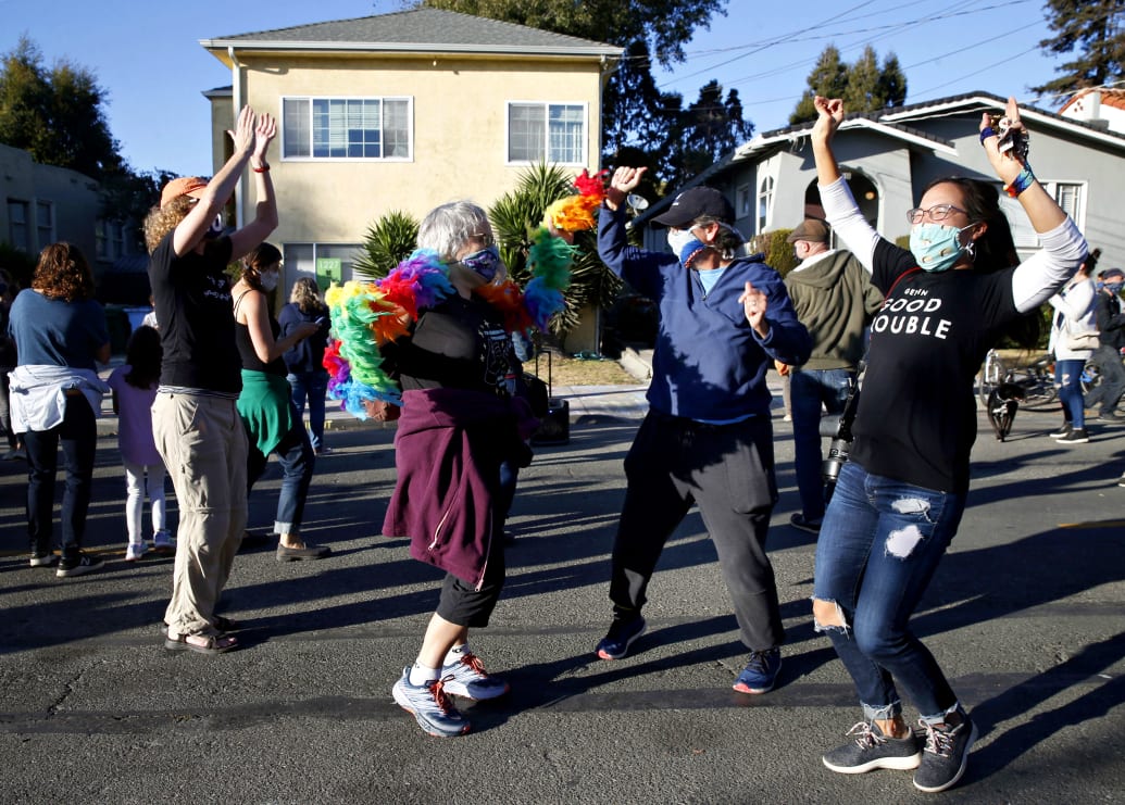 Celebrants dance in the street in front of the childhood home of Kamala Harris in Berkeley, Calif. on Saturday, Nov. 7, 2020 after Joe Biden is declared the winner over President Donald Trump in the presidential election. 