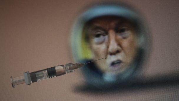 A syringe and a drop of medicine at the tip of a syringe with the portrait of former U.S. President Donald Trump.