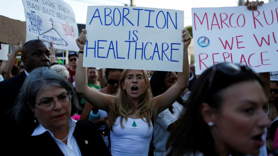 An abortion rights protester holds a sign as she demonstrates after the U.S. Supreme Court ruled in the Dobbs v Women’s Health Organization abortion case, overturning the landmark Roe v Wade abortion decision in Miami.
