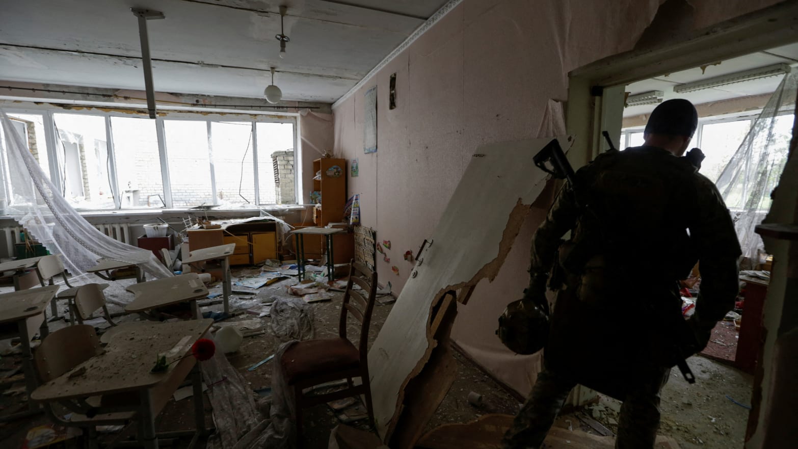 A Ukrainian serviceman at a damaged school building on June 1, 2023